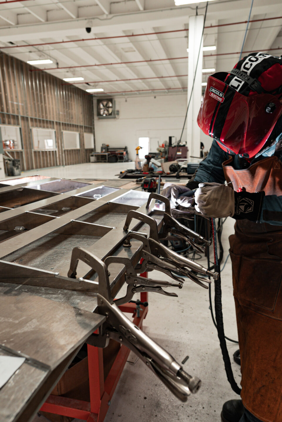 ROA craftsman welding a custom metal frame